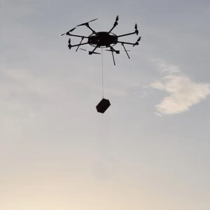 Heavy Lift Multirotor (HLM) Octocopter in Flight Carrying a Load
